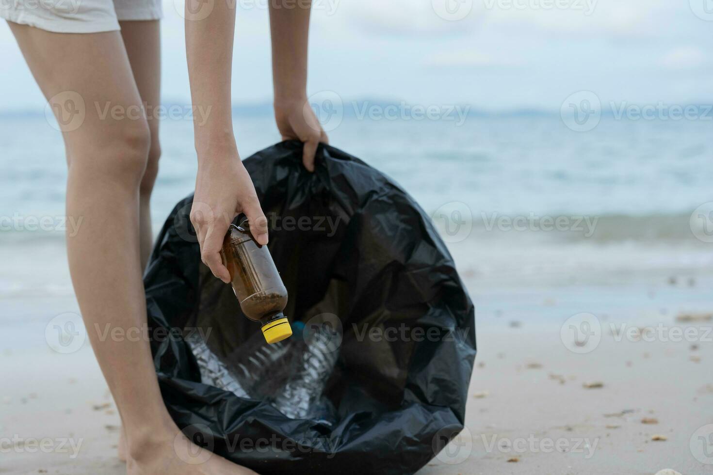 Save ocean. Volunteer pick up trash garbage at the beach and plastic bottles are difficult decompose prevent harm aquatic life. Earth, Environment, Greening planet, reduce global warming, Save world photo