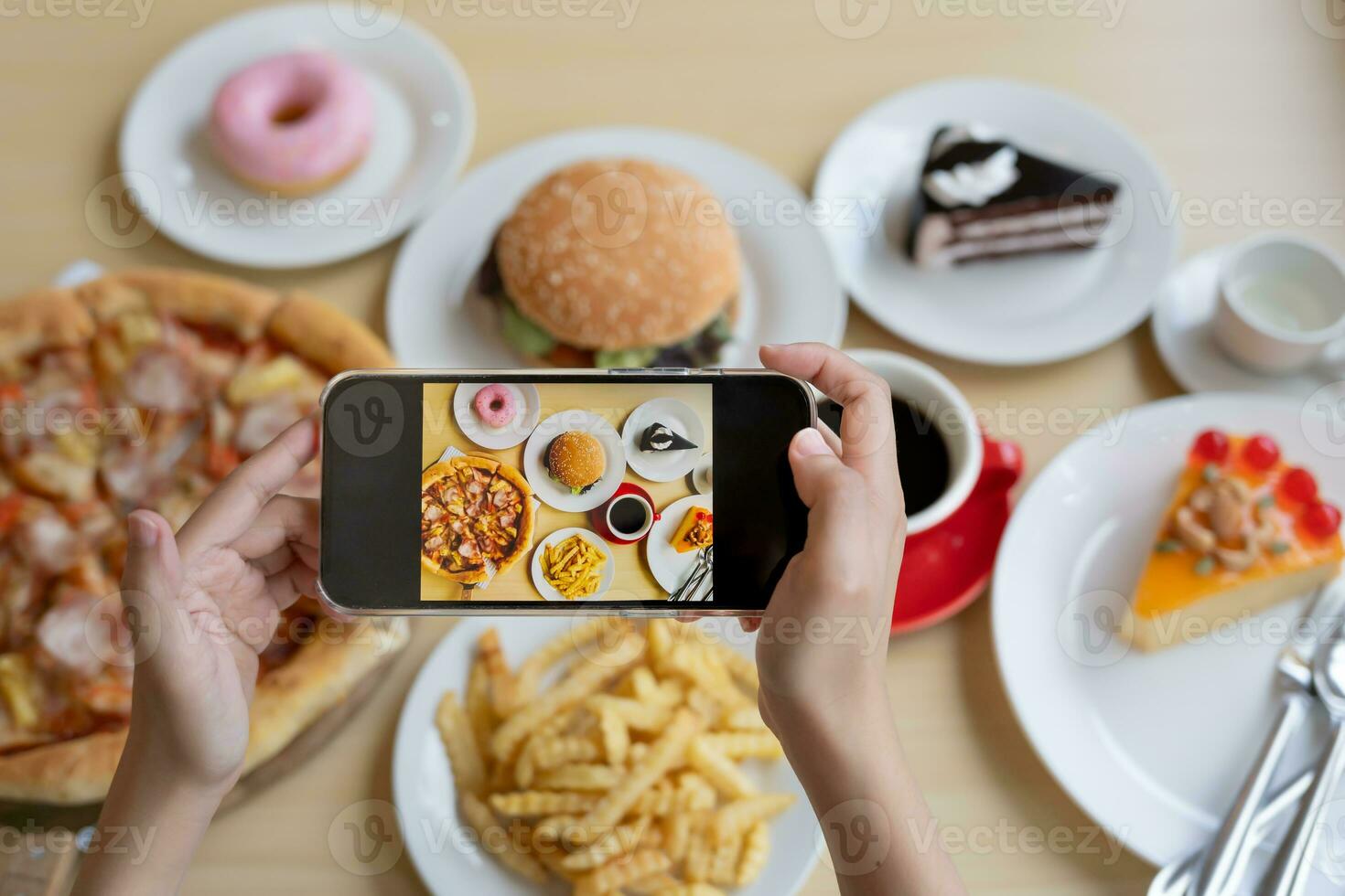 restaurant owner takes a picture of the food on the table with a smartphone to post on a website. Online food delivery, ordering service, influencer, review, social media, share, marketing, interest. photo