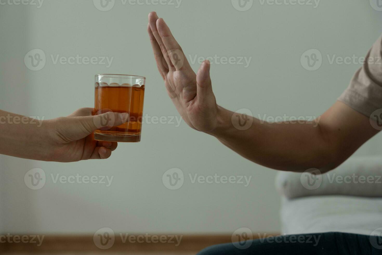 man refuses say no and avoid to drink an alcohol whiskey , stopping hand sign male, alcoholism treatment, alcohol addiction, quit booze, Stop Drinking Alcohol. Refuse Glass liquor, unhealthy, reject photo