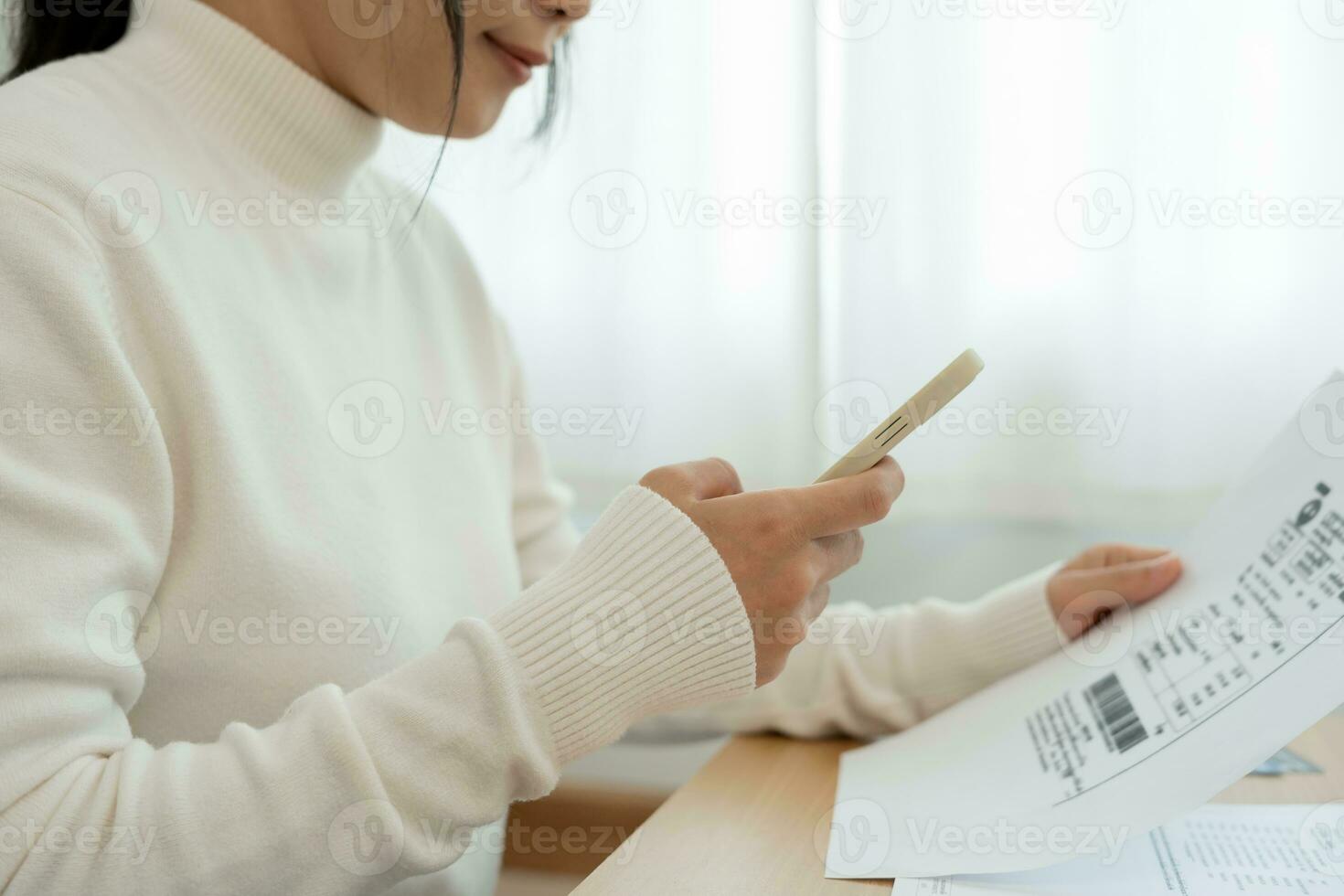 Modern woman use phone to scan barcode or QR codes to pay credit card bill after receive document invoice. payment, receive, paying electricity, digital payments without money, technology, scanning photo