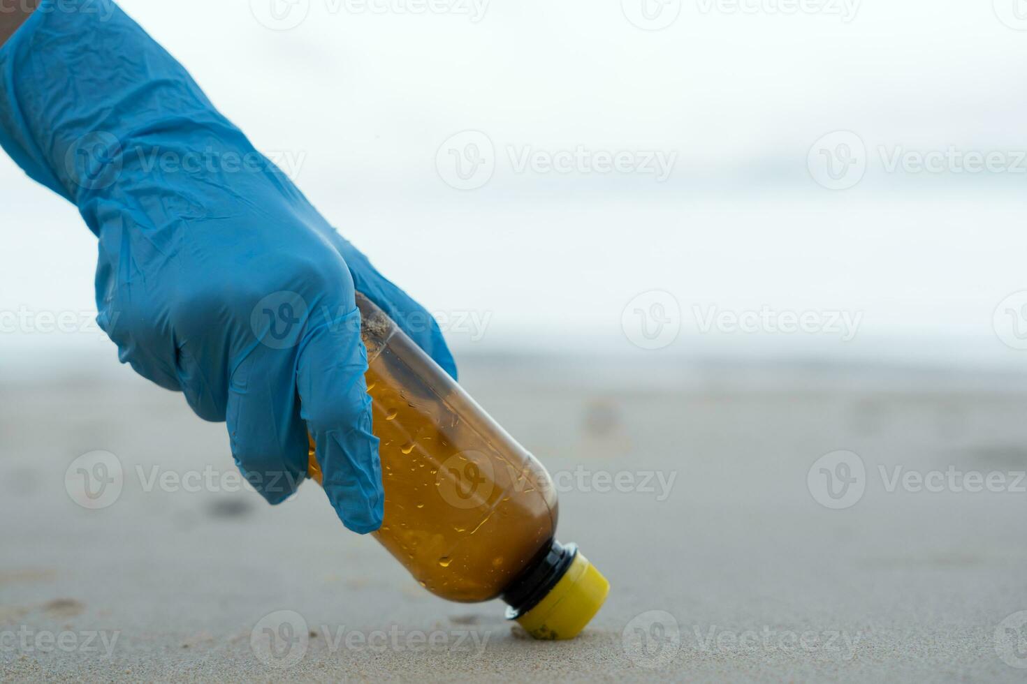 Save water. Volunteer pick up trash garbage at the beach and plastic bottles are difficult decompose prevent harm aquatic life. Earth, Environment, Greening planet, reduce global warming, Save world photo