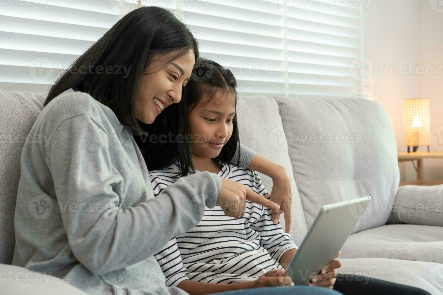 Technology searching on new education by use tablet at home. play back online course, girl student use internet to study, notes homework, world wide. online tutor online course for Asian children. photo