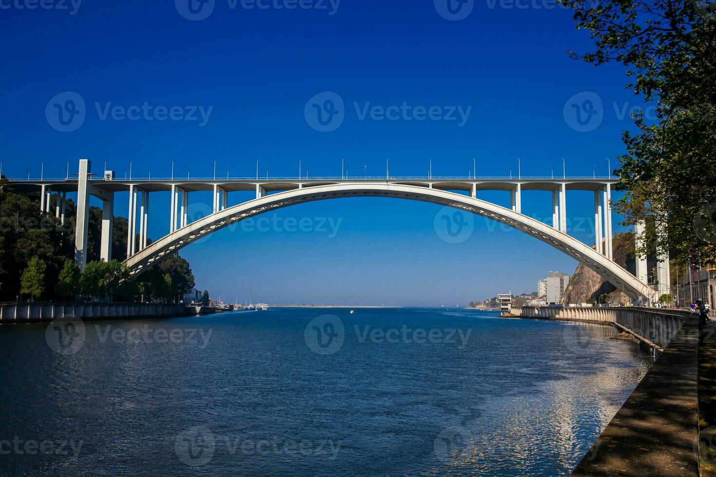 View of the Douro River mouth and the Arrabida Bridge in a beautiful early spring day at Porto City in Portugal photo