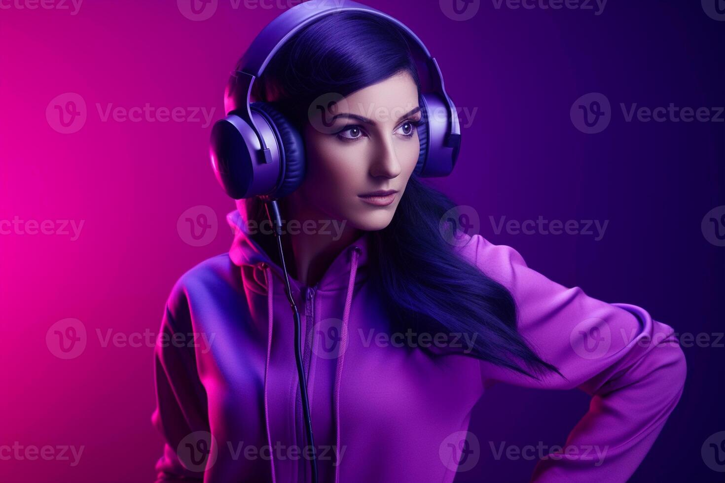 Beautiful young woman listening to music on headphones. Purple background. photo