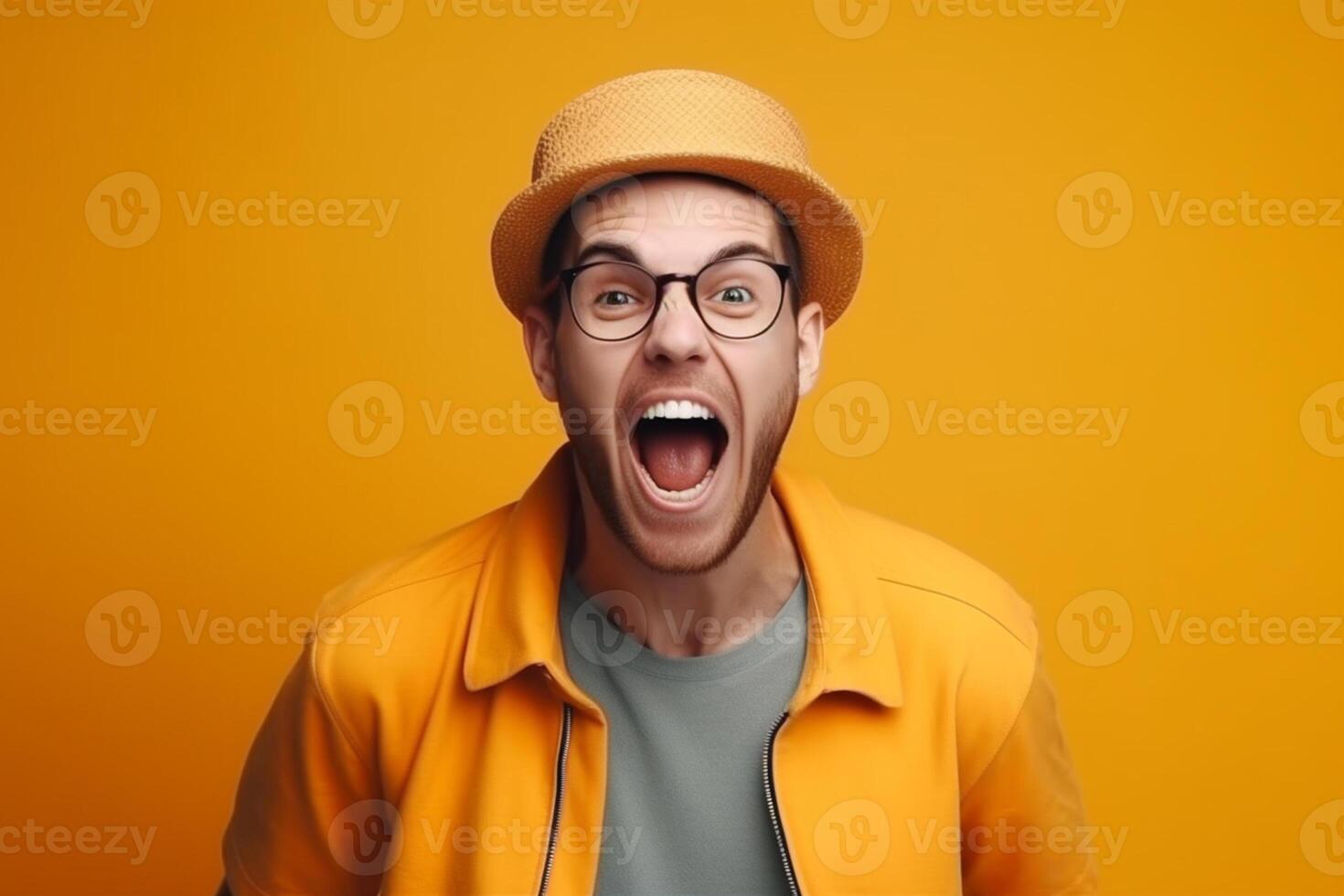 Portrait of a young man screaming isolated over yellow background photo