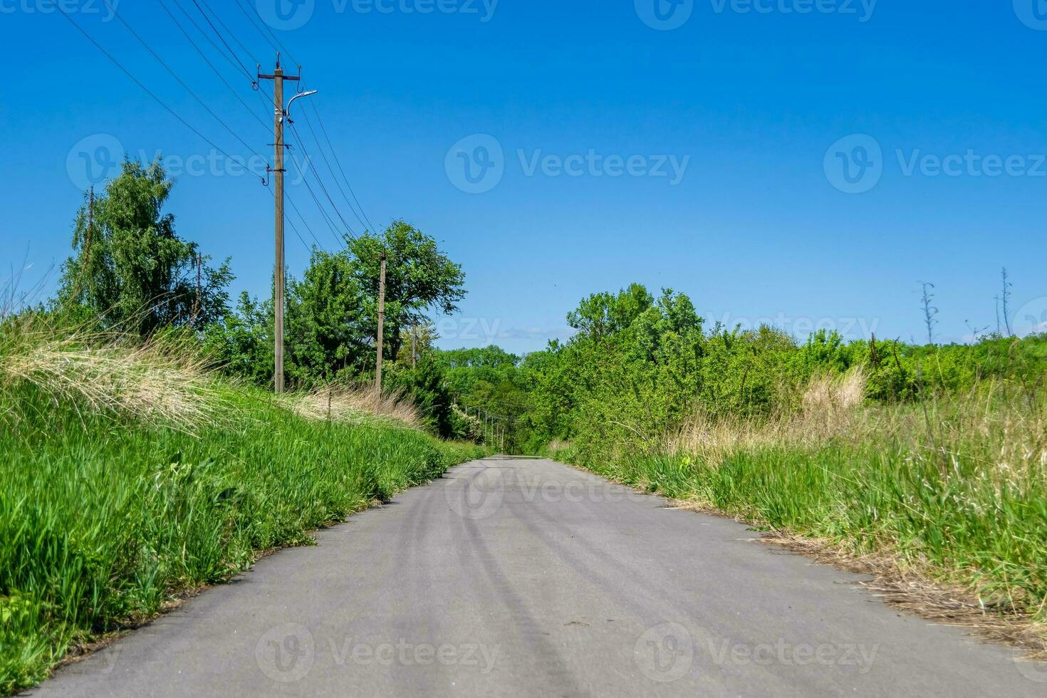 Beautiful empty asphalt road in countryside on colored background photo