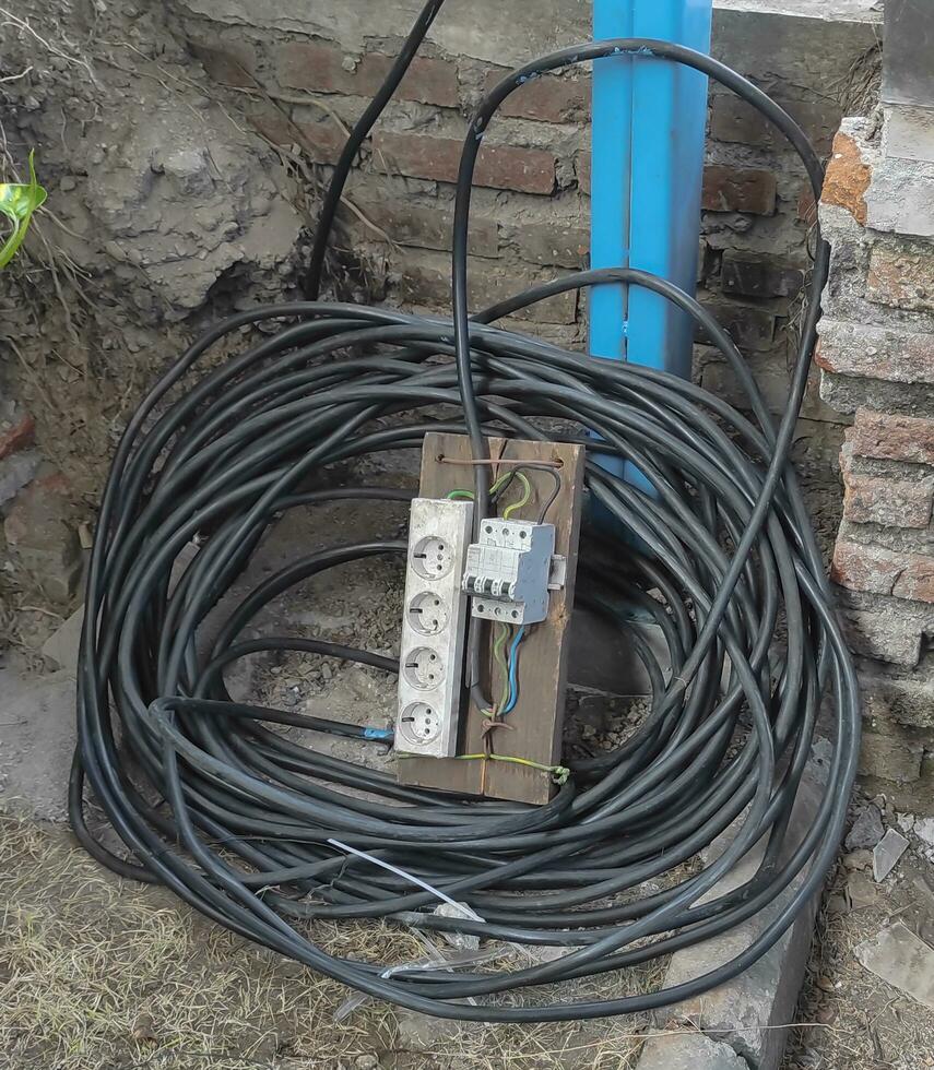 electrical outlet cable is neatly coiled photo