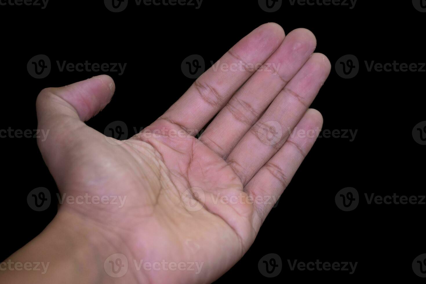 open left hand isolated on black background.One empty male palm hand holding something on black background photo