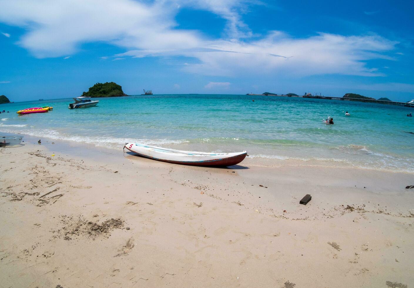 Landscape front view beach blue sea clear sky summer topical tourists and family, there kayak boat sport adventure on beach serve tourists   Nang Ram Beach, Sattahip. photo