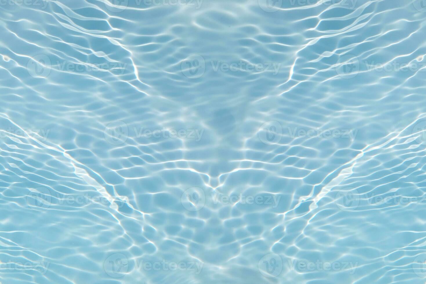 Blue water with ripples on the surface. Defocus blurred transparent blue colored clear calm water surface texture with splashes and bubbles. Water waves with shining pattern texture background. photo