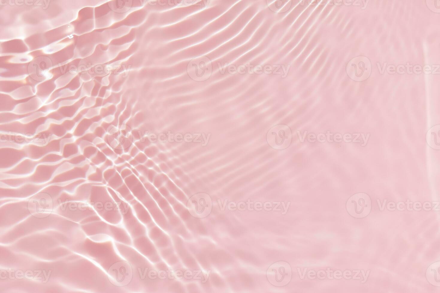 Pink water with ripples on the surface. Defocus blurred transparent white colored clear calm water surface texture with splashes and bubbles. Water waves with shining pattern texture background. photo