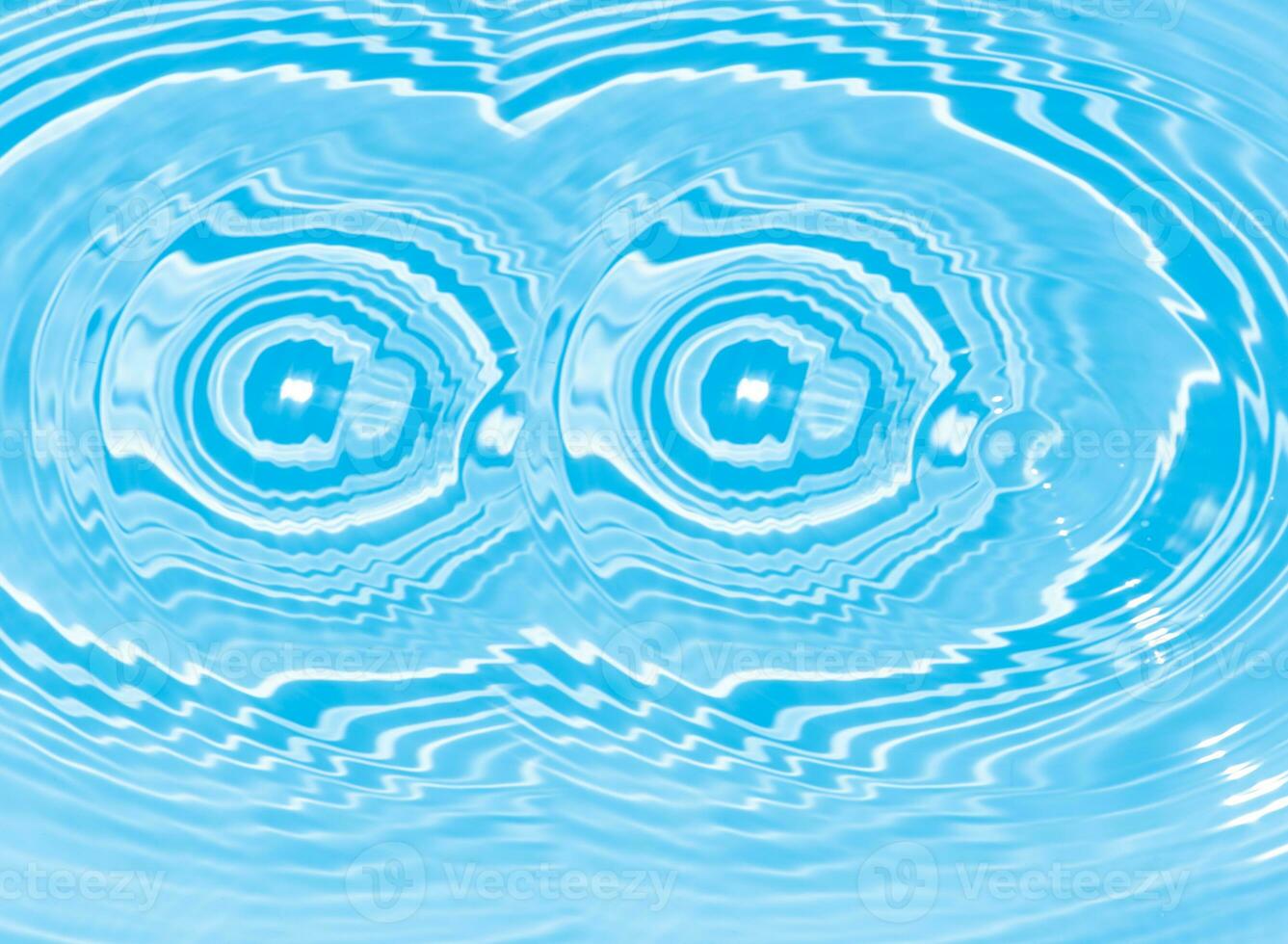 Blue water with ripples on the surface. Defocus blurred transparent blue colored clear calm water surface texture with splashes and bubbles. Water waves with shining pattern texture background. photo