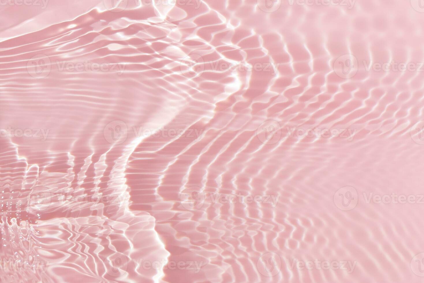 Pink water with ripples on the surface. Defocus blurred transparent white colored clear calm water surface texture with splashes and bubbles. Water waves with shining pattern texture background. photo