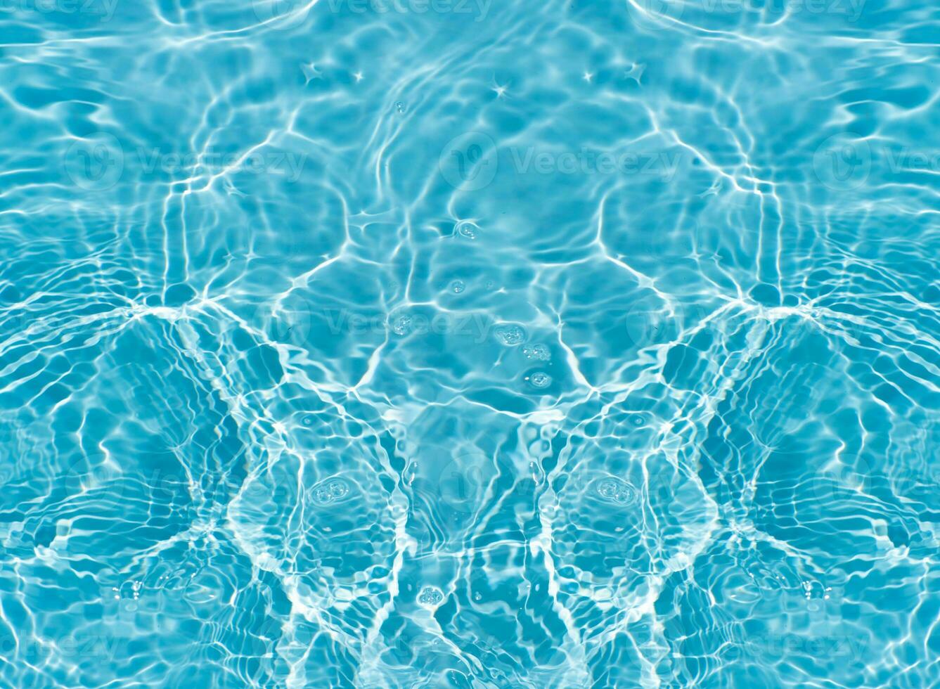 Blue water with ripples on the surface. Defocus blurred transparent blue colored clear calm water surface texture with splashes and bubbles. Water waves with shining pattern texture background. photo