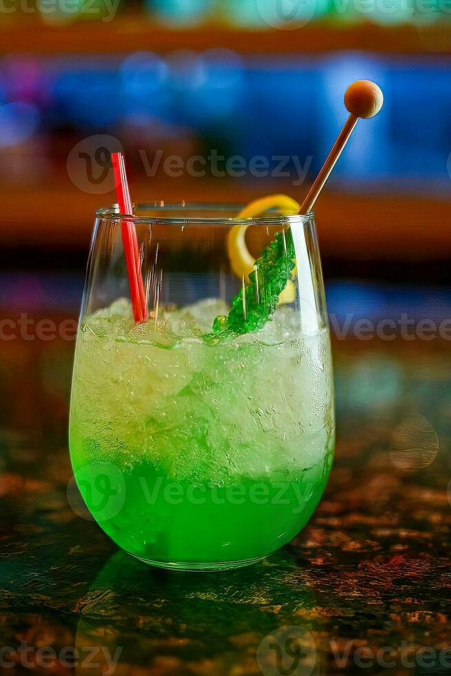 Cocktail Sweet refreshing mint liqueur, with ice and mint leaves green lemonade on the gray concrete stone table, close view photo