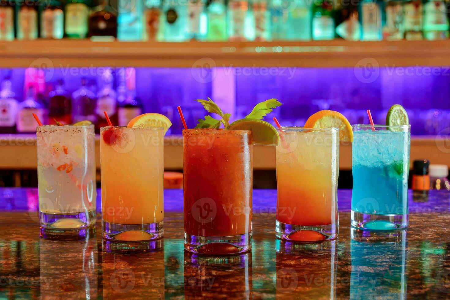 various Cocktail Collection with varying glassware, Handmade Craft Cocktails, dalcoholic beverages. On the bar, in the restaurant, behind it is a liquor showcase. photo