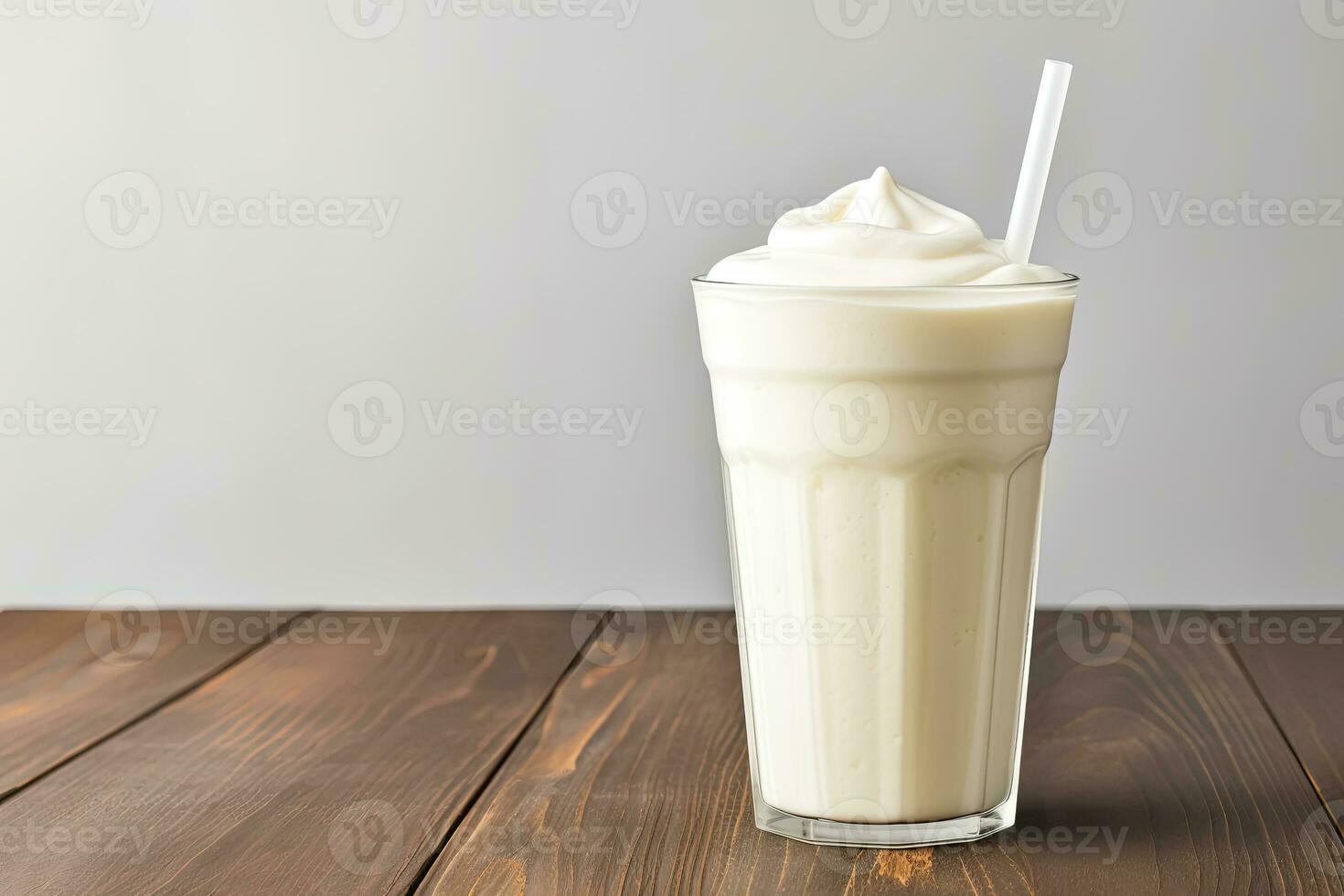 Vanilla cocktail with whipped cream in a tall glass on wooden table. Background with copy space photo