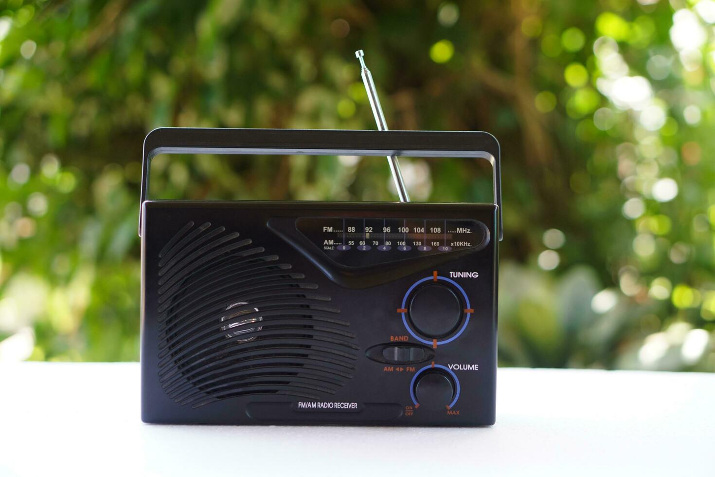 Vintage old transistor radio, placed outdoor. Concept , Analog technology for communication, entertainment, news, songs, music and advertisment photo