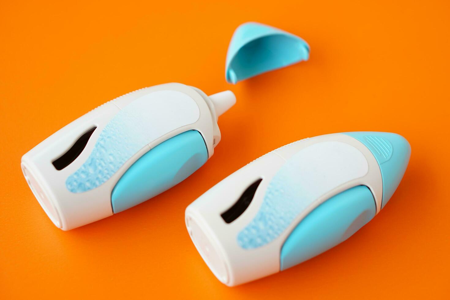 Nasal spray suspension on orange background. Concept, Pharmaceutical products for treatment symptoms of allergic rhinitis. Use under prescription. Health care medical device at home. photo