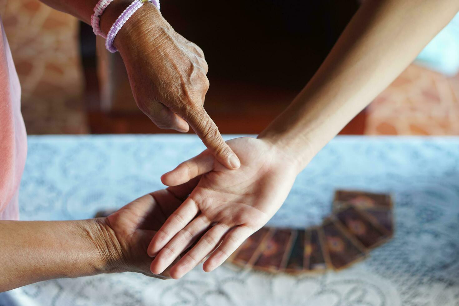 Fortune teller finger points on customer's  palm . Concept , palmistry, astrology. Foretelling, mystery, magic, fortune, fate. Prediction for future life ,events. photo