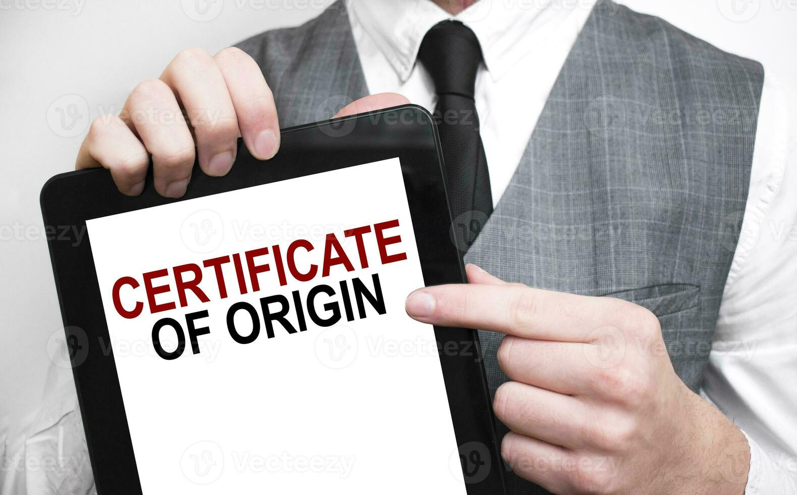 Businessman showing business concept on tablet standing in office CERTIFICATE OF ORIGIN photo
