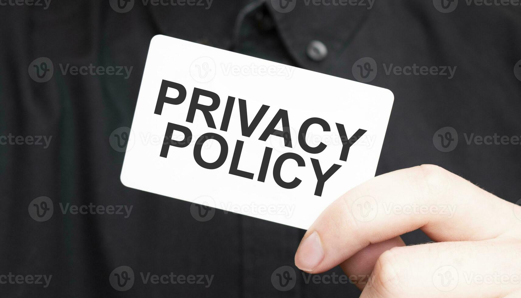 Businessman holding a card with textPRIVACY POLICY , business concept photo