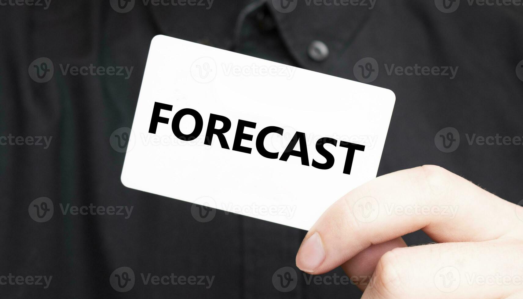 Businessman holding a card with text FORECAST, business concept photo