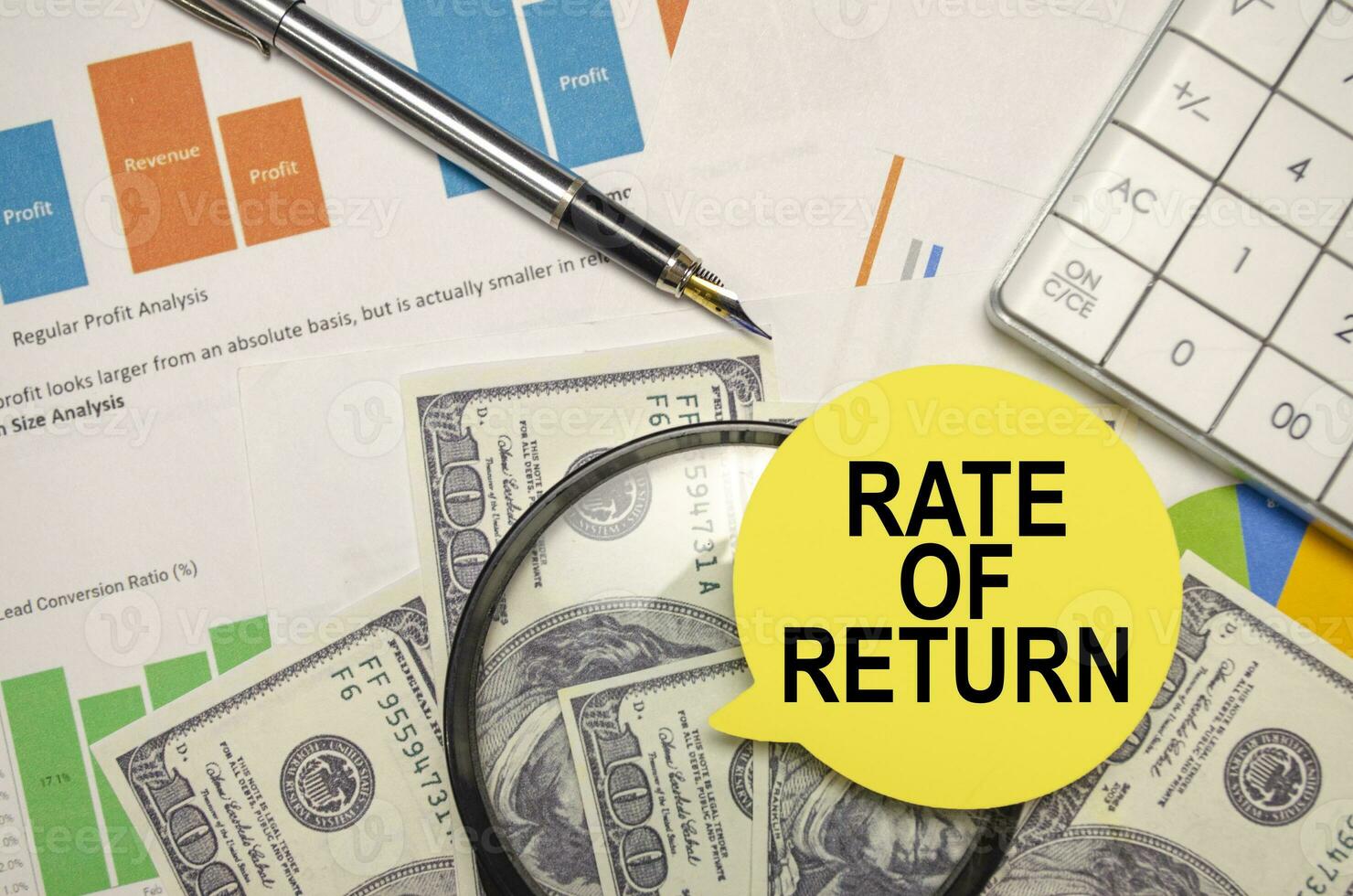 RATE OF RETURN words on yellow sticker with dollars with calculator and