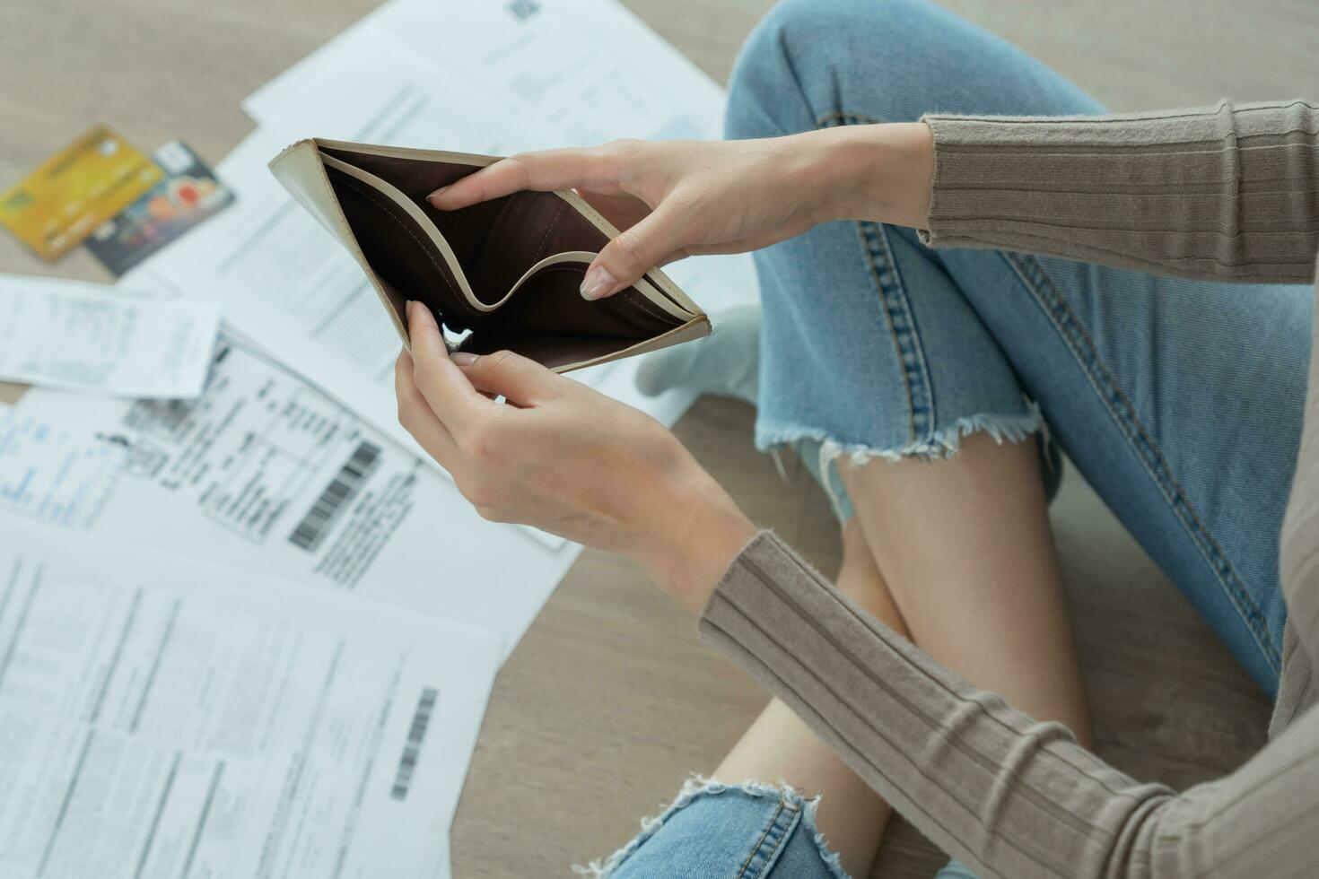 Stressed and headache woman with large bills or invoices no money to pay to expenses and credit card debt. shortage, Financial problem, bankruptcy, mortgage, loan, bankrupt, poor, empty wallet photo
