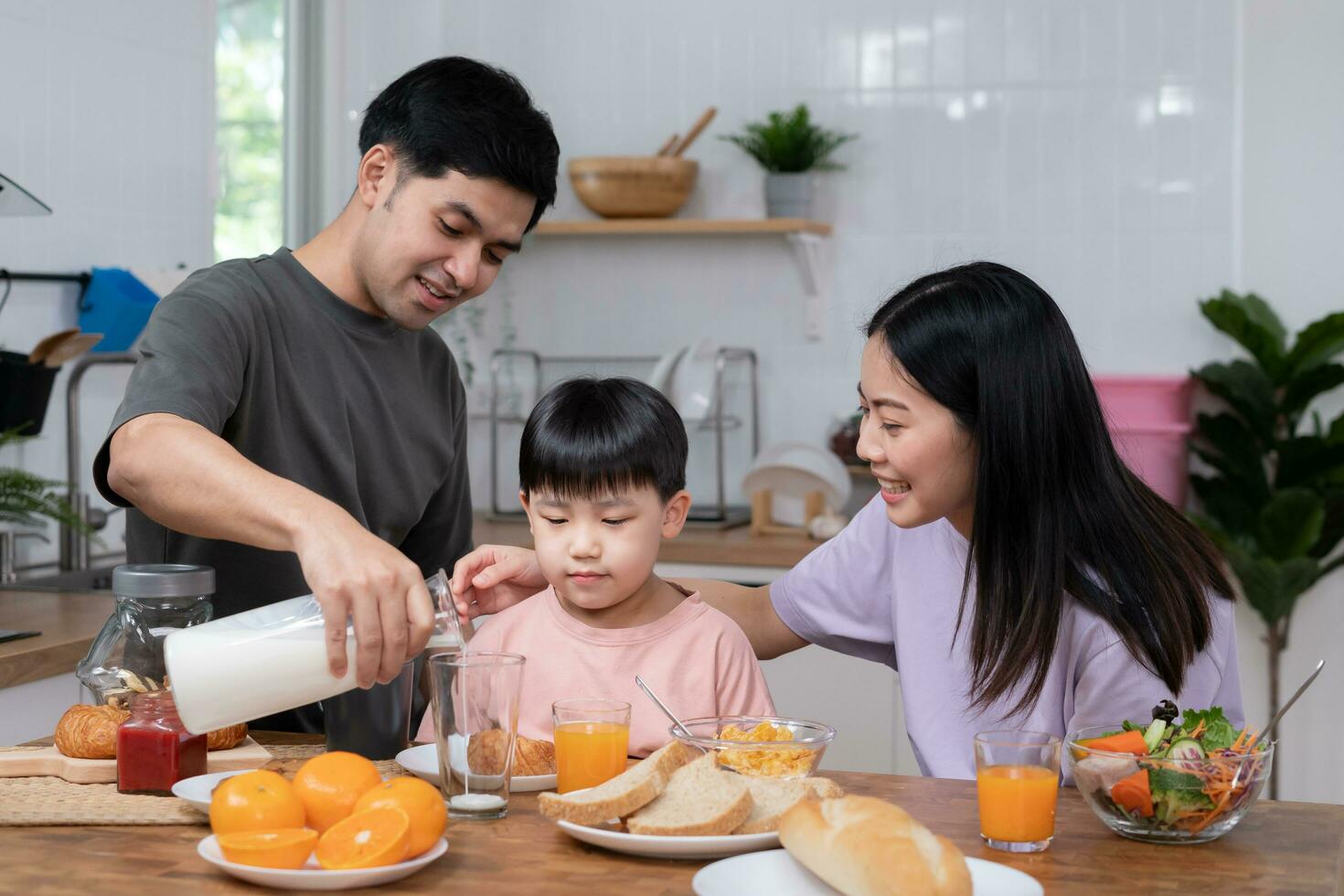 activities together during the holidays. Parents and children are having a meal together during the holidays. father prepare milk for son on morning, enjoy, weekend, vacant, family time, happy. photo