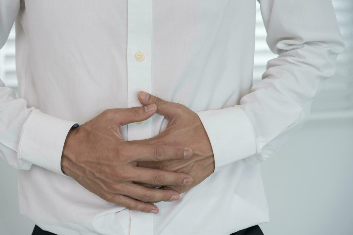 stomach ache. Asian men have abdominal pain, indigestion, gastritis, menstrual cramps, flatulence, diarrhea, distention, colon cancer, belly inflammation problem, suffer food poisoning, abdomen photo