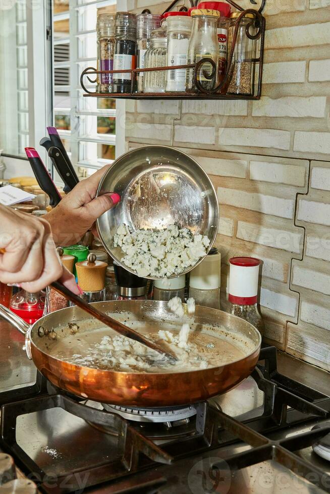 Chef Melts Blue Cheese in Copper Pan on Gas Stove, Culinary Alchemy photo