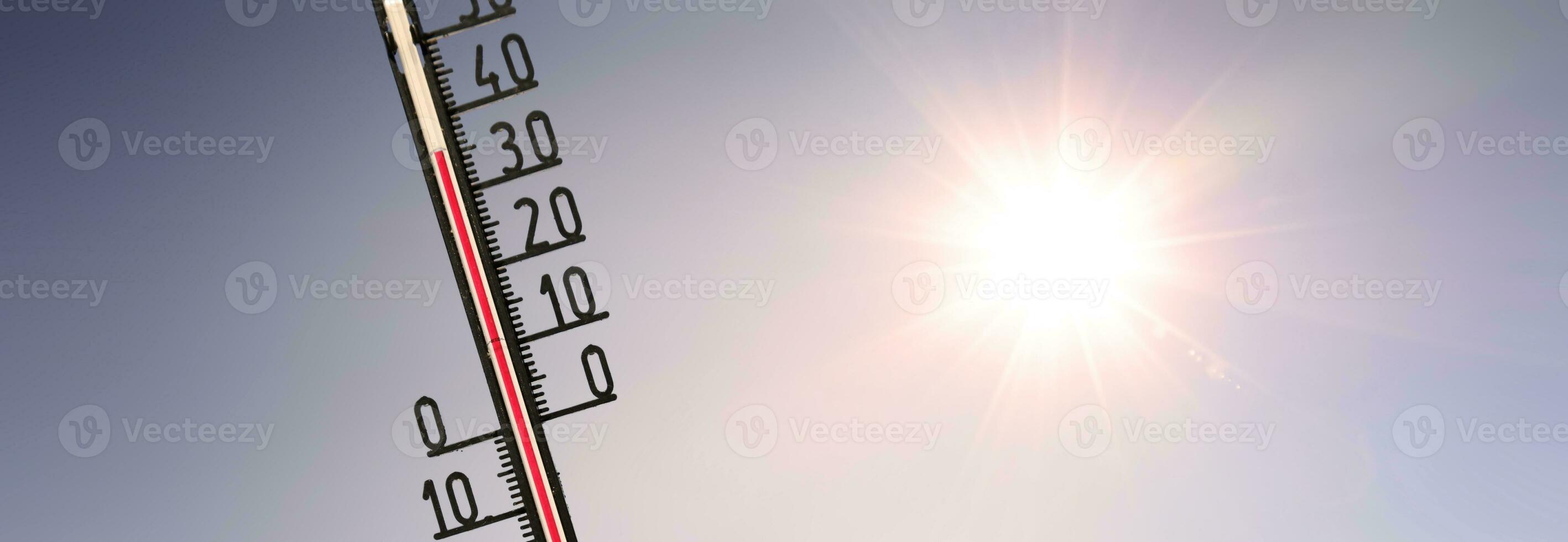 Thermometer with celsius scale showing extreme high temperature. photo