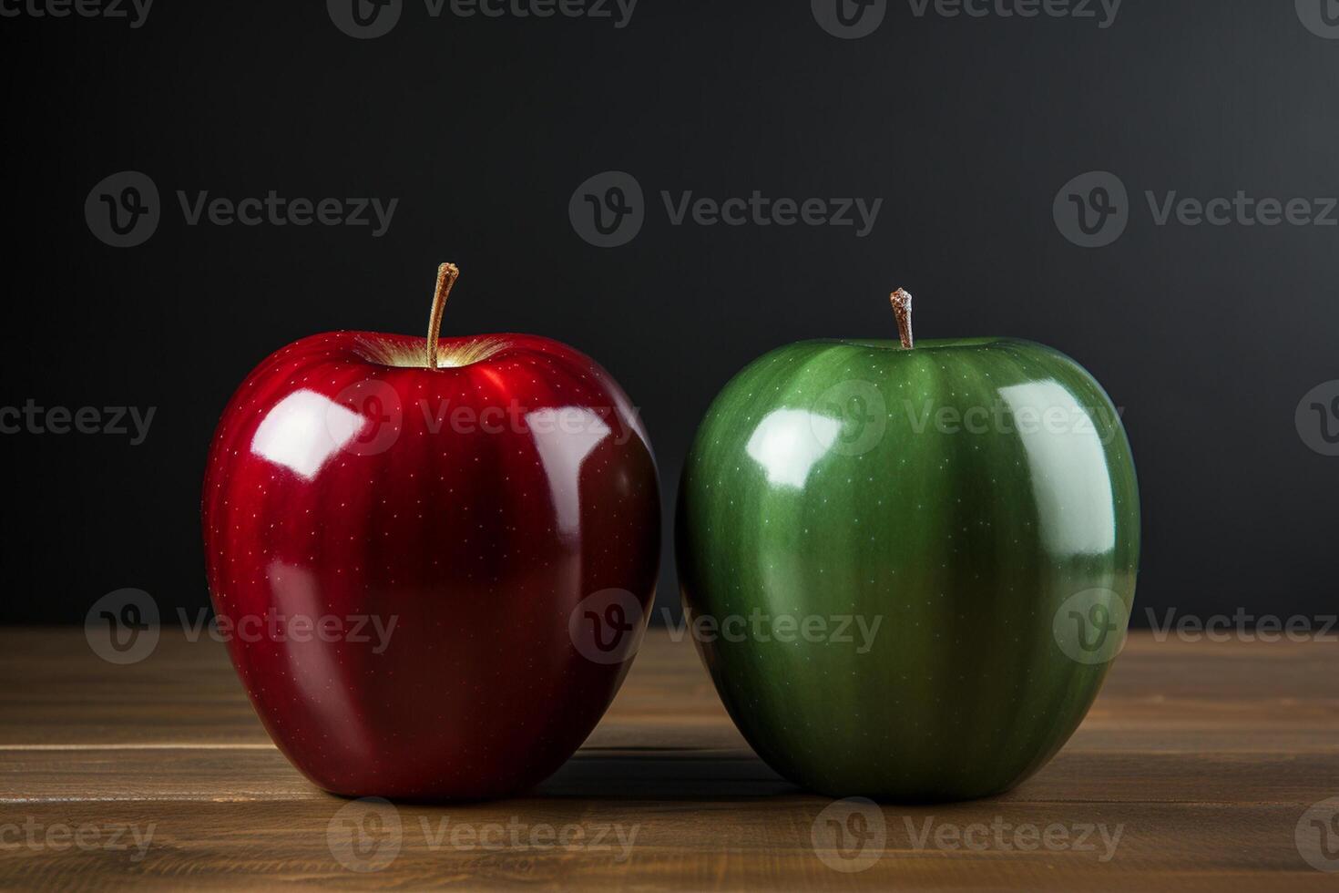 Red and green apples with water drops on wooden table against black background photo