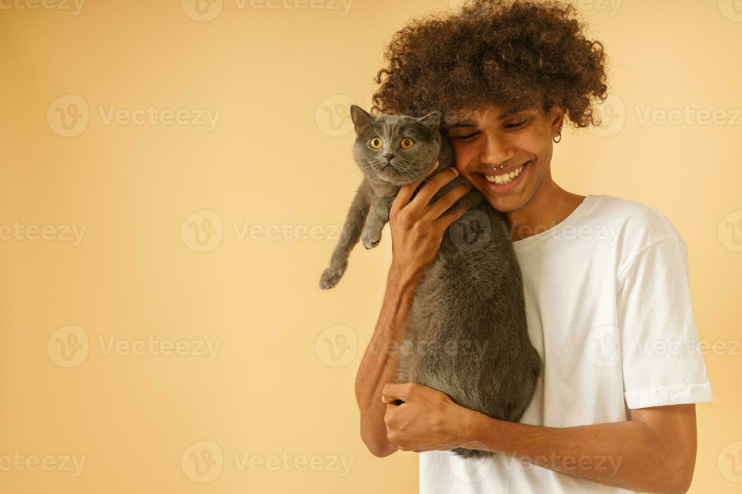Happy man takes care of his grey cat photo