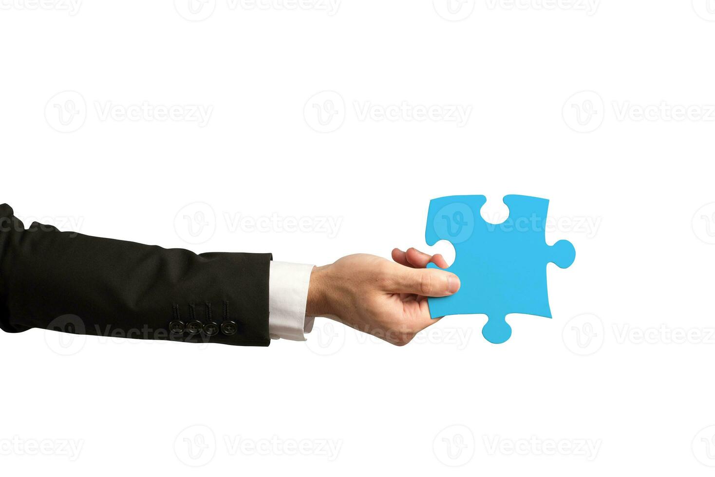 businessman holds a piece of puzzle as teamwork, partnership, integration concept photo