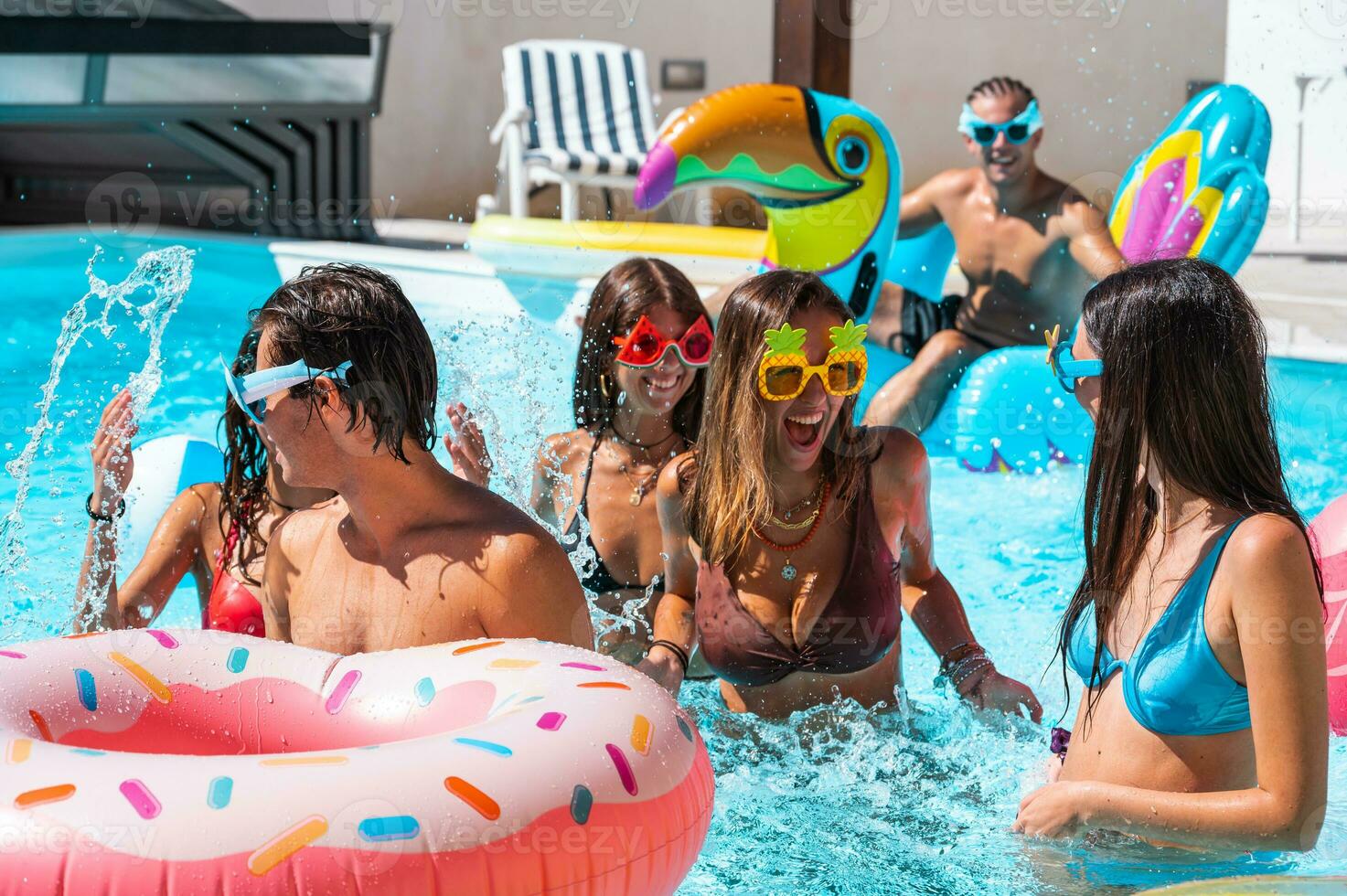 Group of friend play together in the swimming pool photo