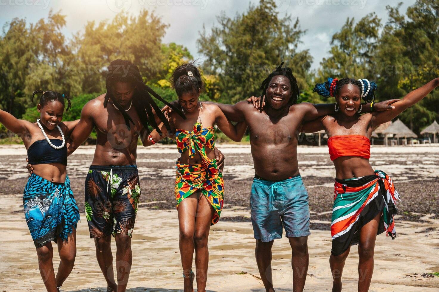 Kenyan people dance on the beach with typical local clothes photo