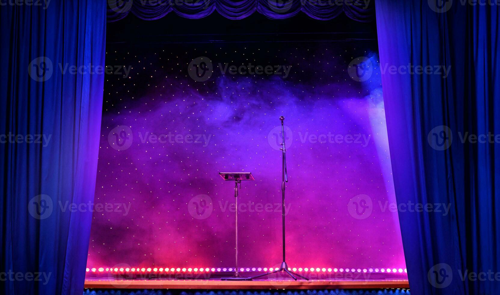 Elegant theatre show with colored spotlights and microphone photo