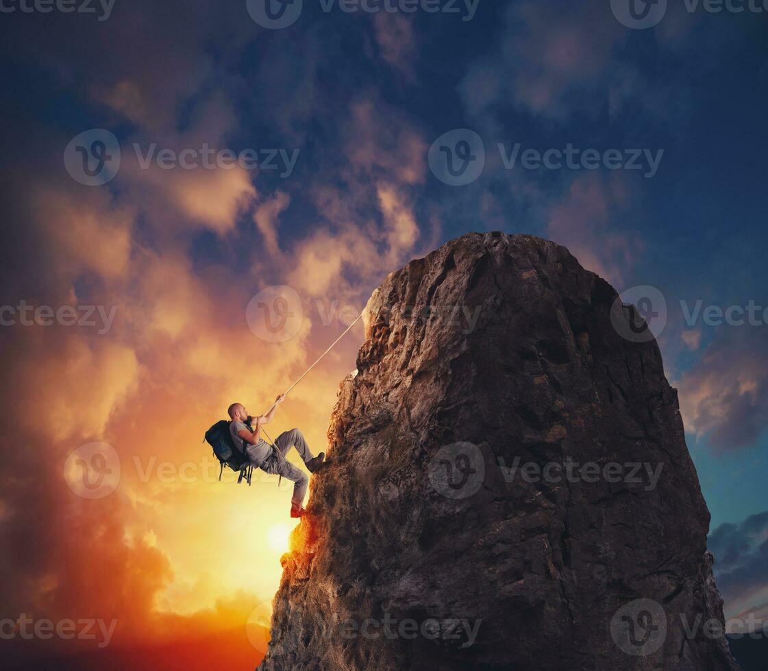 Businessman climb a mountain to get the flag. Achievement business goal and difficult career concept photo