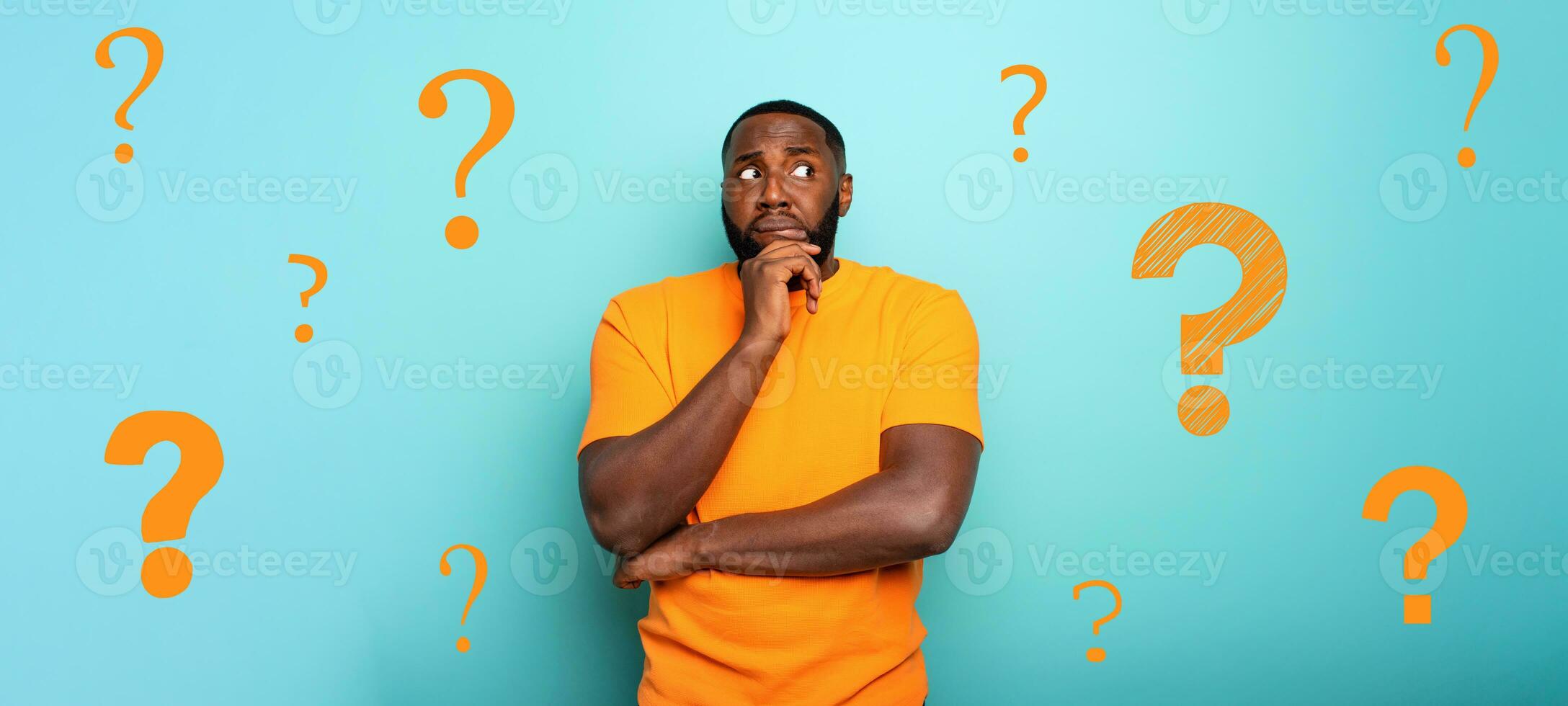 Confuse and pensive expression of a boy with many questions . cyan colored background photo