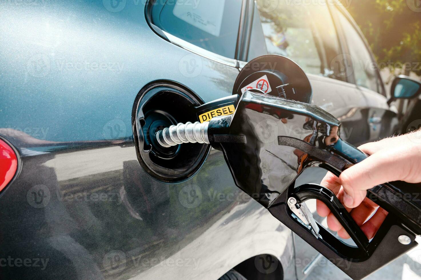 Fuel pump fill a tank of a car in a station photo