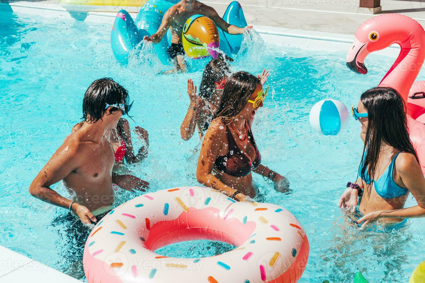 Group of friend play together in the swimming pool photo