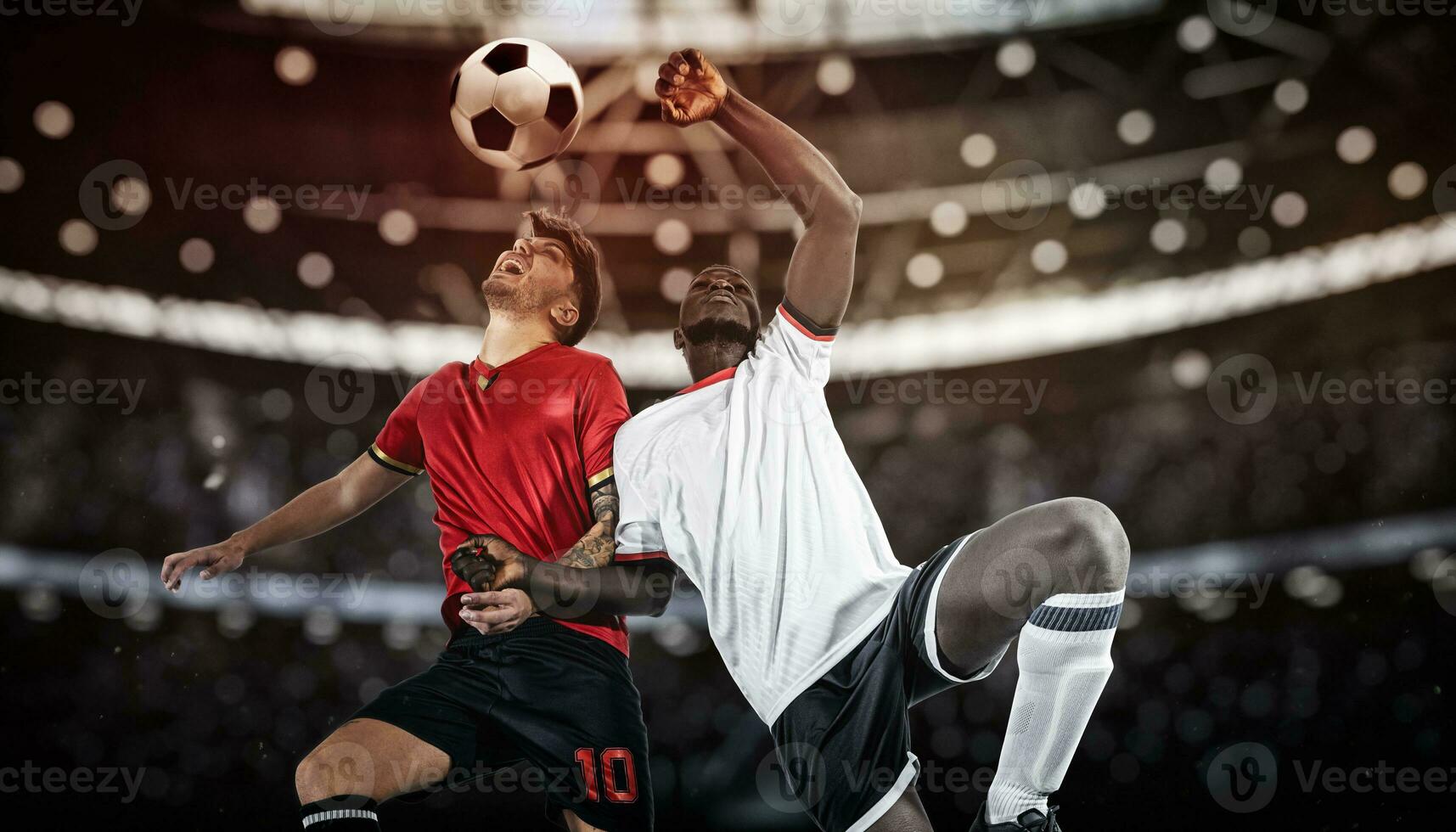 Football action with competing soccer players jumping to hit the ball with head photo
