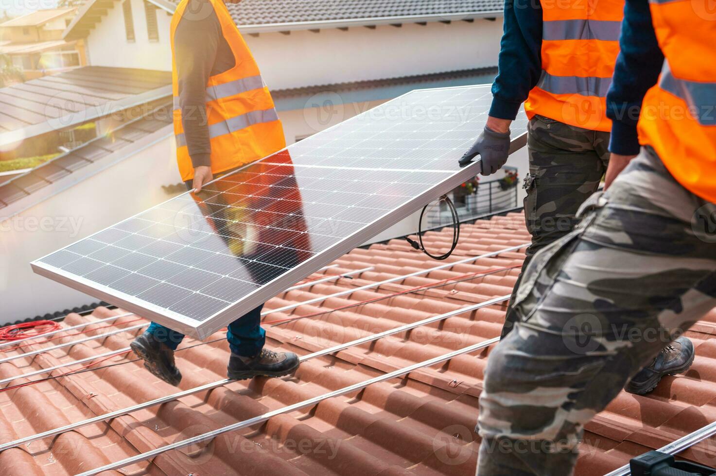 Workers assemble energy system with solar panel for electricity and hot water photo