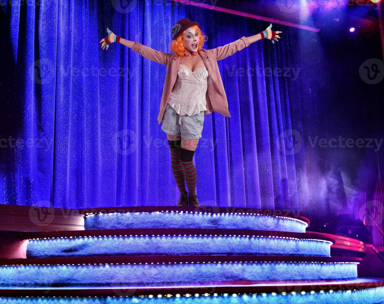 Clown woman in a elegant theater stage ready to start photo