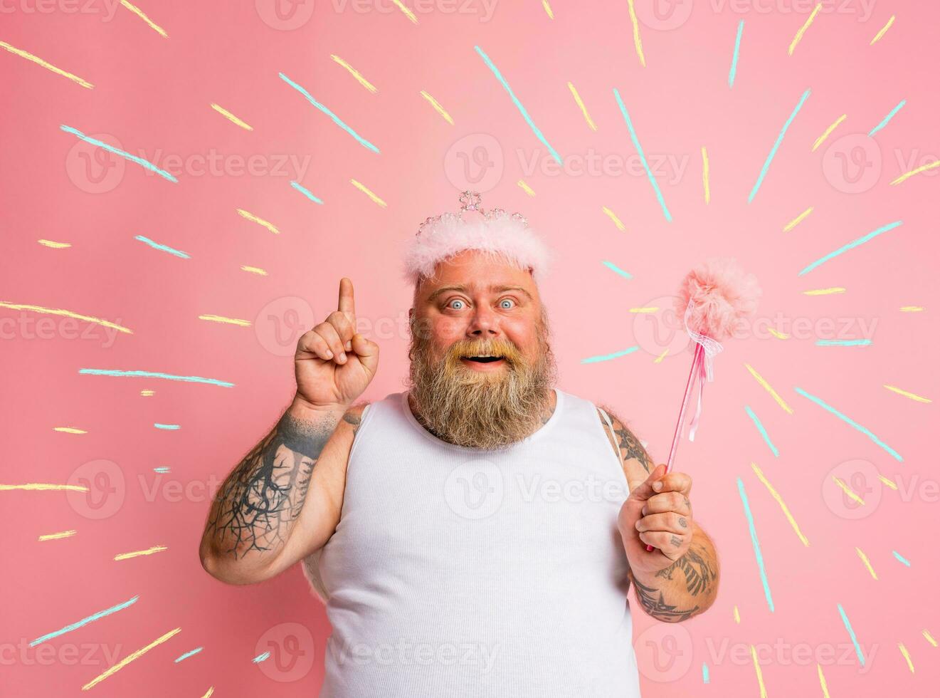 Fat man with tattoos and beard acts like a magic fairy photo