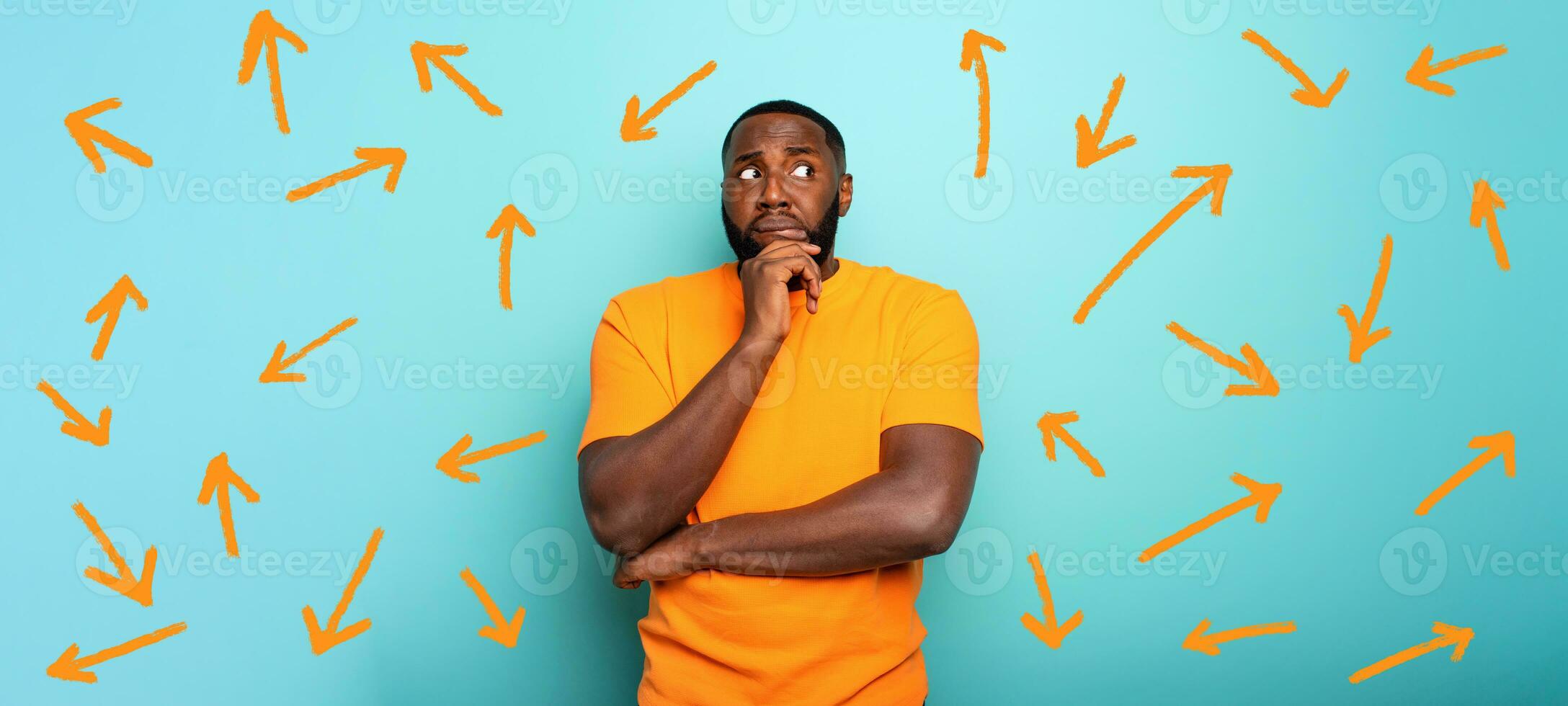 Confuse and pensive expression of a boy with many arrows to follow. cyan colored background photo