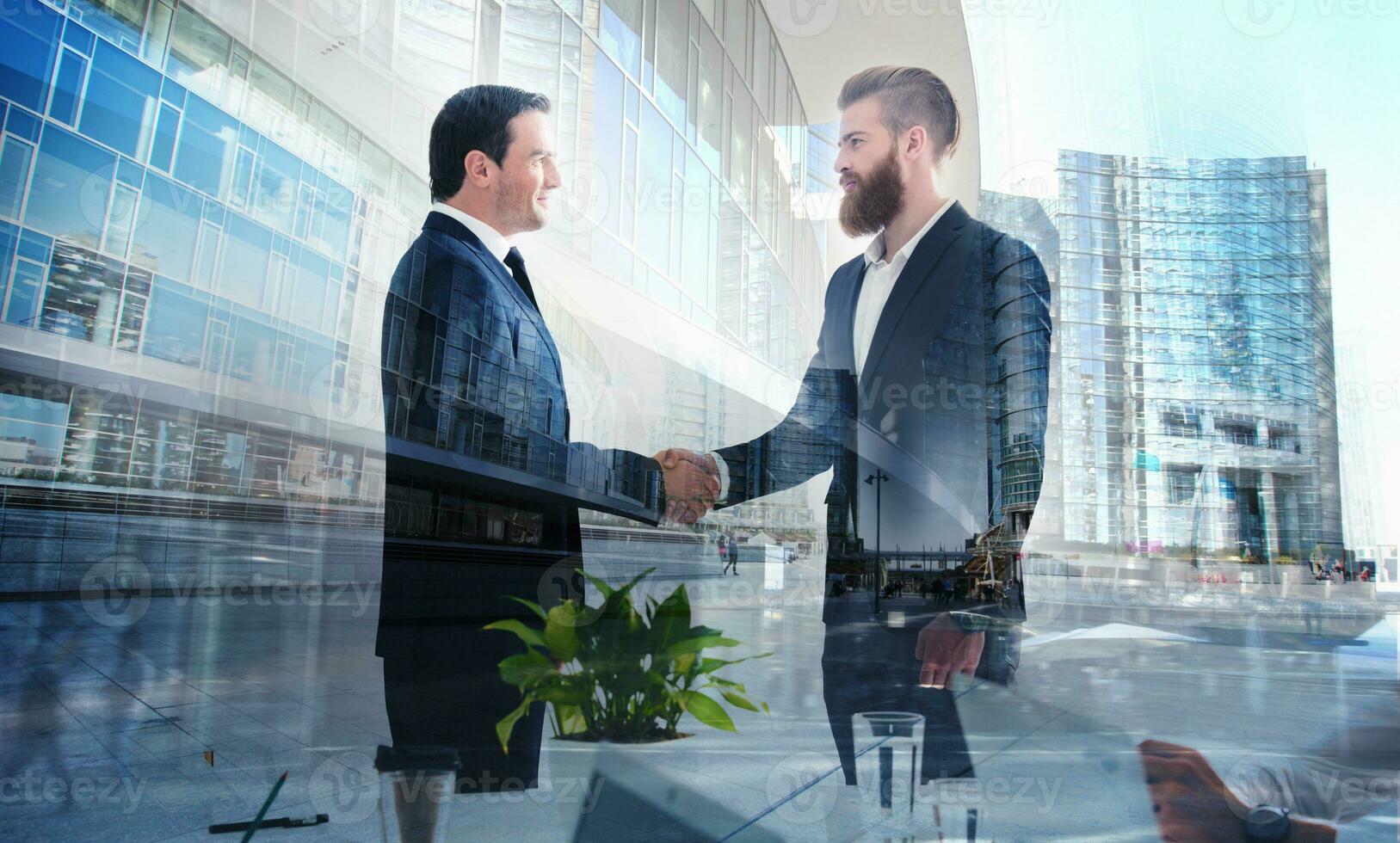 Handshaking business person in office. concept of teamwork and partnership. double exposure photo