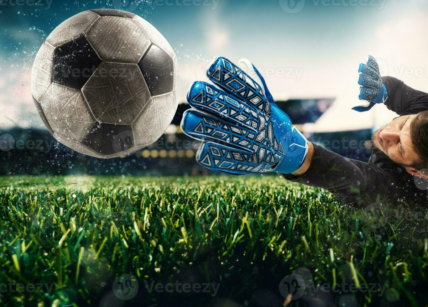 Close up of a goalkeeper catching the ball in the stadium during a football game photo